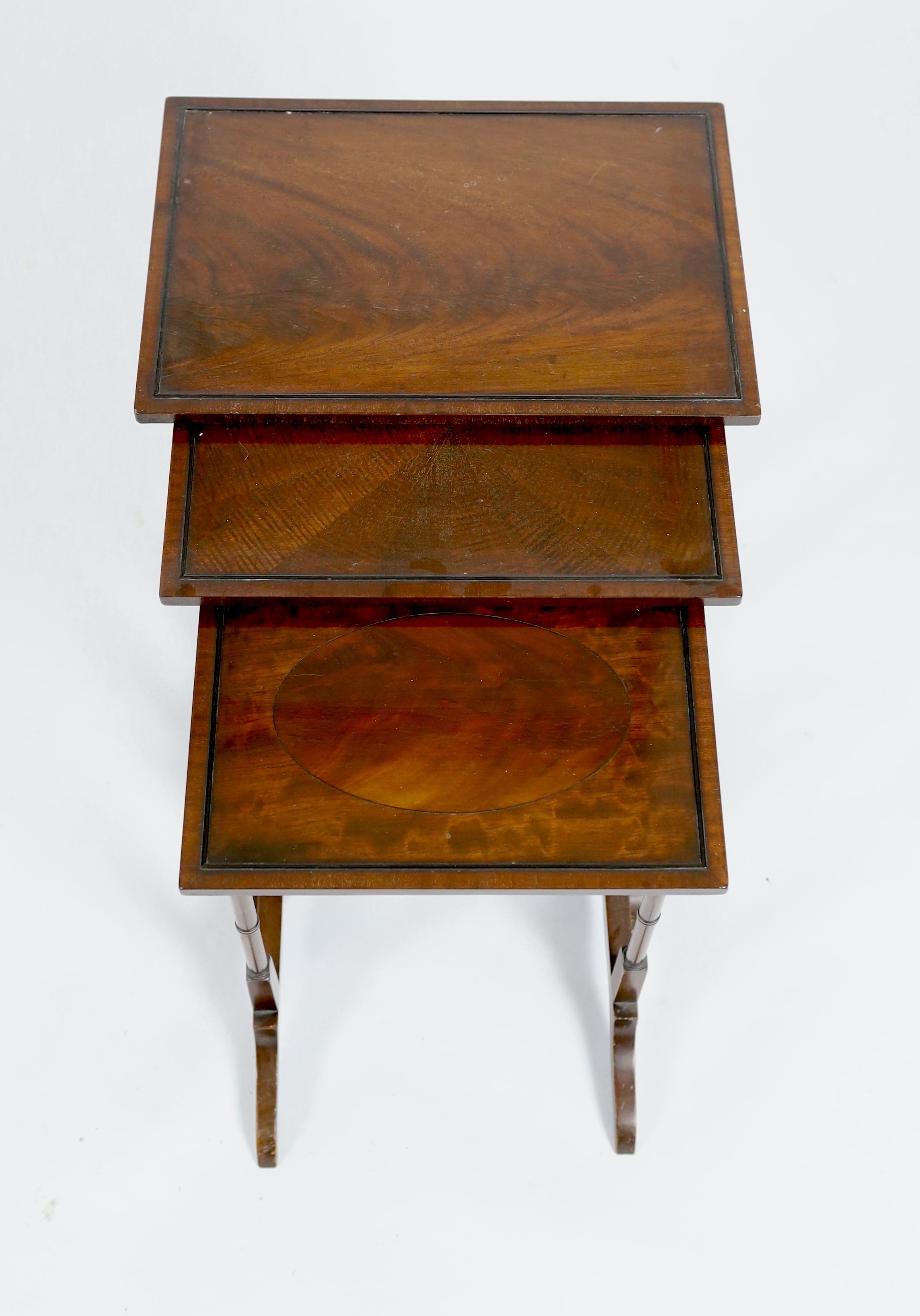 A nest of three rectangular mahogany tea tables, width 45cm depth 32cm height 67cm